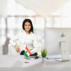girl sitting at office desk with an indian table flag with a brass stand
