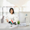 girl sitting at office desk with an indian table flag with a gold plated plastic stand
